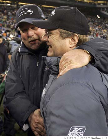 Mike Holmgren  (left) former  head  coach  of  the  Seattle Seahawks  seen  here  hugging  team  owner  and  Microsoft  co-founder  , Paul  Allen.   Holmgren  having   announced   his  retirement  last year  has  since  returned  to  the  NFL  to  become  President  of   Operations  for  the  Cleveland Browns.   Allen   has  since  the  Seahawks   as  a  franchise   labor  over the  last  four  years   and  recently   fired  incumbent  coach,  Jim  Mora Jr,.   His  replacement  is   none  other  than  USC Trojans'  coach  Pete  Carroll.    As  to whether  or   not   Carroll  can  turn  things  around   for  the  franchise   remains  to  be  seen.   The former  coach's   previous   forays in  the   NFL  as  a  head  coach ,  has  proven  to  be  less  than  successful.   He previously  coached   the  New  England Patriots  and  the  New  York  Jets.       picture  appears  courtesy of   Getty  Images/   Rick   Parfitt  .........................