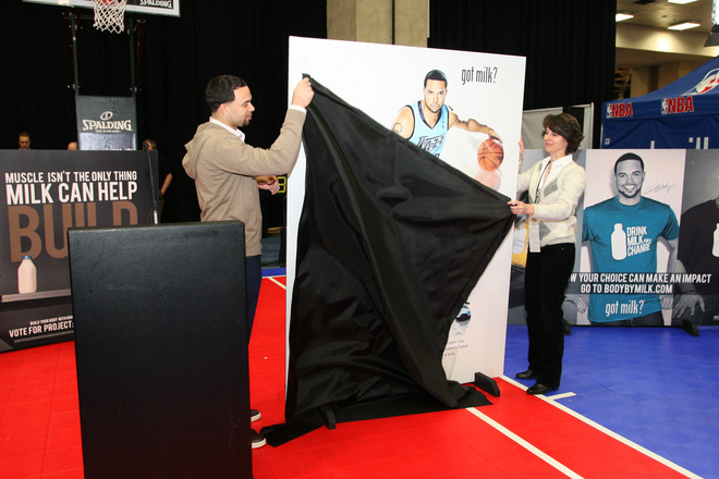 Dallas, February 11th, 2010.  <strong> Deron Williams </strong>(#8 )of the Utah Jazz unveils a photo of himself during the Ene-be-a Milk Press Conference, at Jam Session presented by Adidas during All Star Weekend  in Dallas, Texas. photo  appears courtesy of NBAE/Getty  Images/ Jack  Arent  ...........