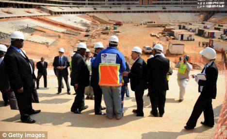 <font face="andalus" size="3">  Building bridges: FIFA president Sepp Blatter <b>(center)</b>   and the 2010 Local Organising Committee (LOC) visit Soccer City Stadium in Johannesburg.  Getty  Images/    Mehtoso   Makulele`   </font>
