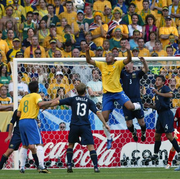 Brazil makes a shot at head by Adriano (7) with defense by Australia's Craig Moore (3) in World Cup soccer action in Munich, Germany on June 18, 2006. Brazil defeated Australia 2-0. UPI _ Arthur Thill ........