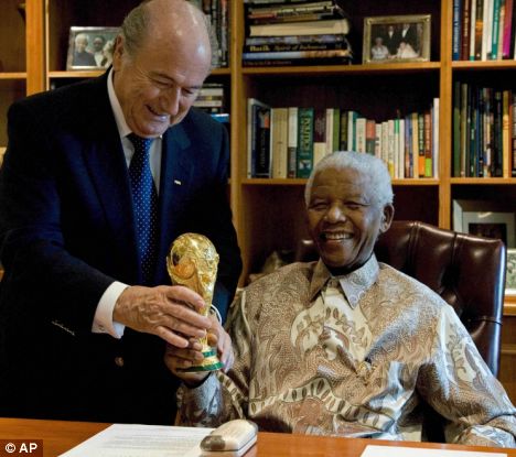 Big prize: FIFA President Sepp Blatter, left, with former South President Nelson Mandela, right, holding a replica of the the World Cup during a brief meeting in Johannesburg, South Africa . Associated Pres/ Daily Mail _ Martin Bergmann ............