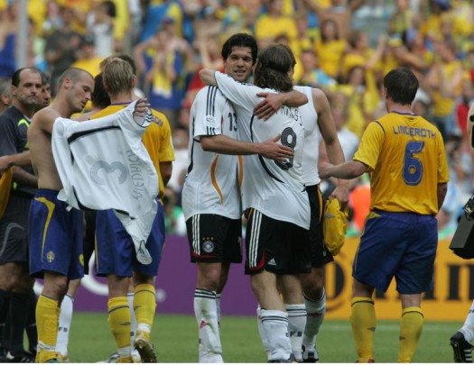 <font face="andalus" size="3"> Michael Ballack hugs Arne Frings during the German team's final celebration after their victory over Sweden 2-0 in the FIFA World Cup in Munich, Germany. UPI Photo/Norbert Rzepka ...</font>