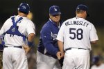 Los Angeles Dodgers pitching coach Rick Honeycutt, center, taps starting pitcher Chad Billingsley, right, while talking to him during the fifth inning of a baseball game in Los Angeles, Tuesday, Sept. 21, 2010. Standing at left is catcher A.J. Ellis. AP Photo/Jae C. Hong