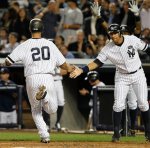 New York Yankees' Alex Rodriguez, right, greets Jorge Posada after Posada scored on Lance Berkman's first-inning, two-run double in the Yankees' 8-3 victory over the Tampa Bay Rays in their baseball game at Yankee Stadium in New York, Tuesday, Sept. 21, 2010. AP Photo/Kathy Willens .....