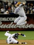 New York Yankees Nick Swisher (33) breaks up a double play on a ball hit by Mark Teixeira as Tampa Bay Rays' Evan Longoria leaps to avoid the out Swisher in the seventh inning of a baseball game at Yankee Stadium in New York, Tuesday, Sept. 21, 2010. AP Photo/Kathy Willens